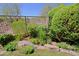 Lush desert landscaping with blooming flowers and lush greenery in backyard at 32710 N 71St St, Scottsdale, AZ 85266