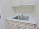 Close-up of a laundry sink with neutral cabinets and ample counter space for folding at 32710 N 71St St, Scottsdale, AZ 85266