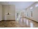 Expansive living room featuring a chandelier, marble flooring, neutral palette, and lots of natural light at 32710 N 71St St, Scottsdale, AZ 85266