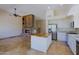 Open floorplan featuring an island kitchen and living room with stone fireplace at 32710 N 71St St, Scottsdale, AZ 85266