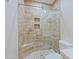 Modern tiled shower with glass door and rainfall shower head, plus a built-in corner seat at 32710 N 71St St, Scottsdale, AZ 85266