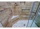 Custom shower showcasing wood-like tiles and pebble floor design, with grab bar and glass door at 32710 N 71St St, Scottsdale, AZ 85266