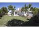 Lush backyard with a spacious lawn, mature trees, and a view of the home's rear exterior at 3314 E Draper Cir, Mesa, AZ 85213