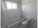 This bathroom features a shower over tub combination with a window at 3314 E Draper Cir, Mesa, AZ 85213