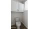 White toilet with white cabinets in a clean and bright bathroom at 3314 E Draper Cir, Mesa, AZ 85213