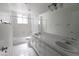 Bathroom with double sinks, large mirror, and bathtub with shower, providing functionality at 3314 E Draper Cir, Mesa, AZ 85213