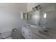 This bathroom features double sinks with a large mirror and decorative light fixture at 3314 E Draper Cir, Mesa, AZ 85213