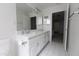 Bathroom with double sinks, white cabinets, and a tiled floor creating a clean feel at 3314 E Draper Cir, Mesa, AZ 85213