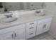 Bathroom showcasing double sinks, vanity with ample storage, and a tiled countertop at 3314 E Draper Cir, Mesa, AZ 85213