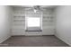 Bedroom with custom built-ins, window seat, and neutral carpet at 3314 E Draper Cir, Mesa, AZ 85213