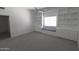 This bedroom boasts a ceiling fan, grey carpet, built-in bookcases and a window seat at 3314 E Draper Cir, Mesa, AZ 85213