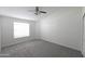 Bright bedroom with neutral carpet, a large window, and a ceiling fan at 3314 E Draper Cir, Mesa, AZ 85213