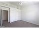 Bright bedroom featuring neutral gray carpet and white closet with a loft and ladder at 3314 E Draper Cir, Mesa, AZ 85213