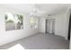 Bright bedroom with large windows, ceiling fans, and a spacious closet with shelving at 3314 E Draper Cir, Mesa, AZ 85213