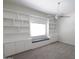 Bedroom with custom built-ins, a window seat, and a ceiling fan at 3314 E Draper Cir, Mesa, AZ 85213