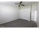 Bedroom with neutral carpet, closet, and a ceiling fan at 3314 E Draper Cir, Mesa, AZ 85213