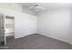 Bedroom with neutral carpet, a closet, and open door to a kitchen at 3314 E Draper Cir, Mesa, AZ 85213
