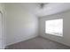 Bedroom with a window, neutral carpet, and a ceiling fan at 3314 E Draper Cir, Mesa, AZ 85213