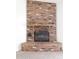 Close-up view of the brick fireplace with a wooden mantel at 3314 E Draper Cir, Mesa, AZ 85213