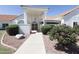Inviting front entrance featuring decorative shrubbery and desert landscaping at 3314 E Draper Cir, Mesa, AZ 85213