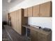 Spacious garage featuring ample storage with custom cabinets and countertop space at 3314 E Draper Cir, Mesa, AZ 85213