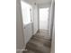 Hallway with wood floors showcasing entrances to bedrooms and a view to the second level at 3314 E Draper Cir, Mesa, AZ 85213