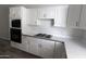 Kitchen featuring white cabinetry, a cooktop, and built-in microwave at 3314 E Draper Cir, Mesa, AZ 85213