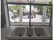 Kitchen sink features a triple basin and backyard view at 3314 E Draper Cir, Mesa, AZ 85213