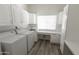Well-equipped laundry room with modern washer, dryer, and custom cabinetry at 3314 E Draper Cir, Mesa, AZ 85213