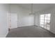 Bright, spacious living room with sliding glass doors and neutral carpeting at 3314 E Draper Cir, Mesa, AZ 85213