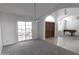 Open living area with neutral carpet, sliding glass doors, and beautiful architectural features at 3314 E Draper Cir, Mesa, AZ 85213