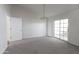 Open living area with neutral carpet and sliding glass doors at 3314 E Draper Cir, Mesa, AZ 85213