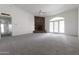 Spacious living room boasts a cozy fireplace, ceiling fan, and multiple entryways at 3314 E Draper Cir, Mesa, AZ 85213