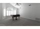 Living room features a piano and lots of natural light from the windows at 3314 E Draper Cir, Mesa, AZ 85213