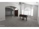 Large open living room with a piano and arched entryway at 3314 E Draper Cir, Mesa, AZ 85213
