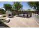 Paver patio features an outdoor kitchen with a fireplace, built-in grill, and seating at 3314 E Draper Cir, Mesa, AZ 85213