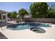 Swimming pool and spa surrounded by a concrete deck and enclosed by block walls for privacy at 3314 E Draper Cir, Mesa, AZ 85213