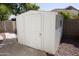 White storage shed in the backyard, providing extra storage space at 3314 E Draper Cir, Mesa, AZ 85213