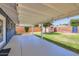 The home's backyard offers a covered patio, lush lawn, and a mix of open space and landscaping at 3344 N 62Nd Pl, Scottsdale, AZ 85251