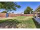 Green backyard offering grass, privacy walls, and partial view of a mountain behind the brick wall at 3344 N 62Nd Pl, Scottsdale, AZ 85251