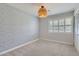 Cozy bedroom featuring a patterned accent wall, a ceiling light, and a window at 3344 N 62Nd Pl, Scottsdale, AZ 85251