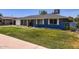 Charming single-story home with lush green lawn, blue paint, updated windows, and a private front yard at 3344 N 62Nd Pl, Scottsdale, AZ 85251