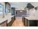 Open kitchen featuring a marble island, stainless steel appliances, and dark green cabinets at 3344 N 62Nd Pl, Scottsdale, AZ 85251