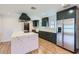 Beautiful kitchen featuring a marble island, stainless steel appliances, and dark green cabinets at 3344 N 62Nd Pl, Scottsdale, AZ 85251