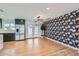 Bright and airy living area with wood floors, statement wallpaper, modern light fixture, and an open floor plan at 3344 N 62Nd Pl, Scottsdale, AZ 85251