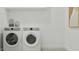 A clean laundry room features side by side appliances and white walls at 3780 E Gold Mountain Ave, San Tan Valley, AZ 85143