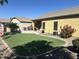 Spacious backyard featuring a well-maintained lawn and a covered patio, perfect for outdoor gatherings at 45091 W Gavilan Dr, Maricopa, AZ 85139