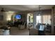 Inviting living room with a dining area, neutral walls, plush carpeting, and plenty of natural light at 45091 W Gavilan Dr, Maricopa, AZ 85139