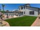 Backyard featuring a sparkling pool, lush lawn, BBQ area, and plenty of space for outdoor enjoyment and entertaining at 4933 E Downing St, Mesa, AZ 85205