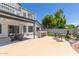 Expansive backyard featuring a covered patio with outdoor kitchen, dining area, bar seating, and well-maintained landscaping at 4933 E Downing St, Mesa, AZ 85205